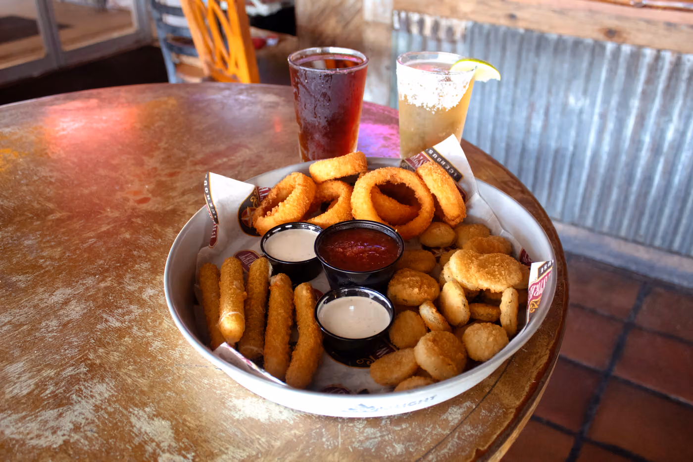 An appetizer spread with a cold beer