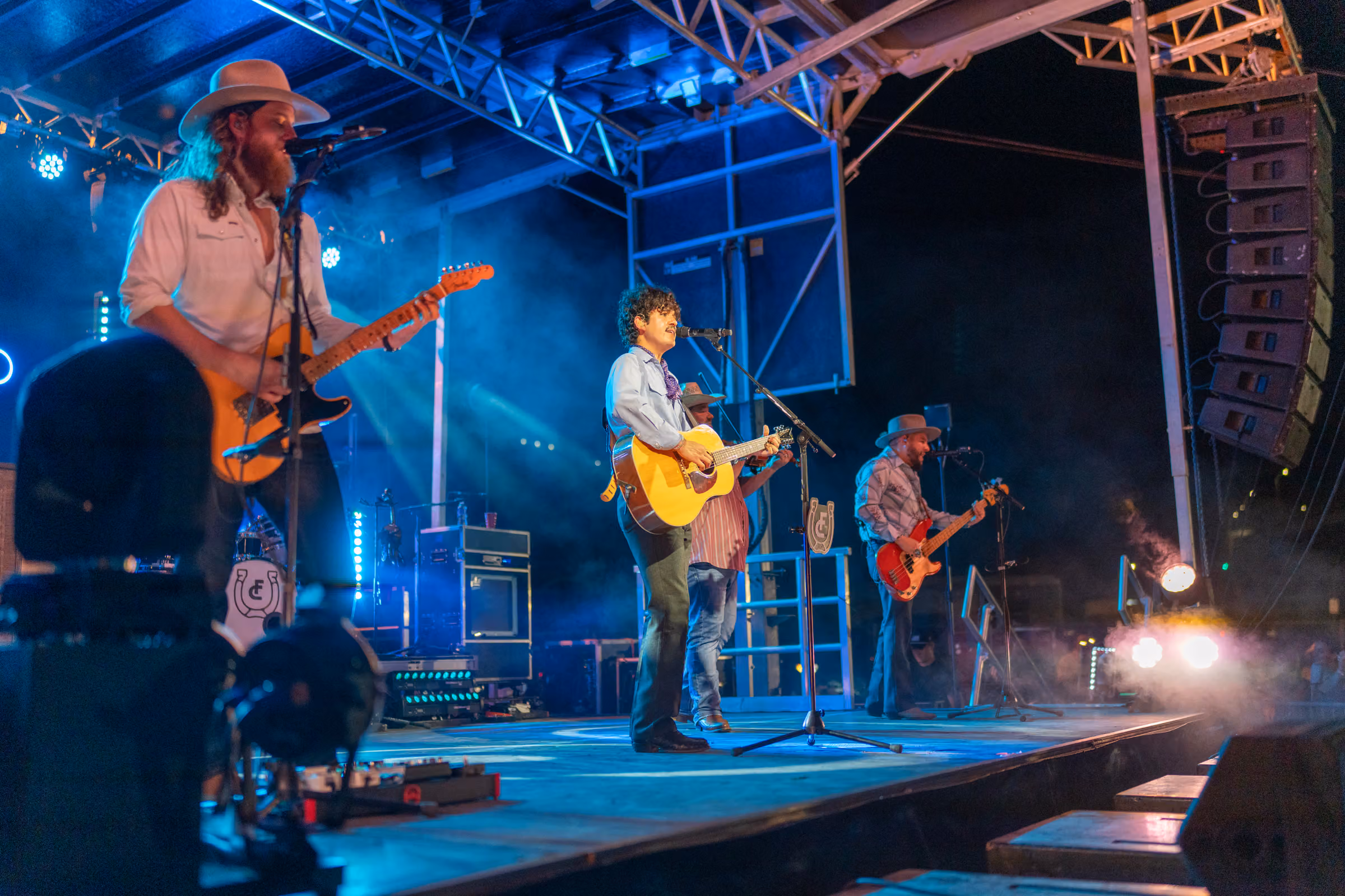 A band on stage in front of the Downtown crowd