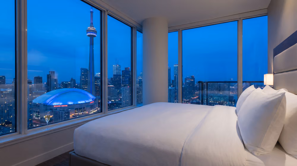 A hotel room with a Toronto skyline view (placeholder render, replace with the client’s photography)