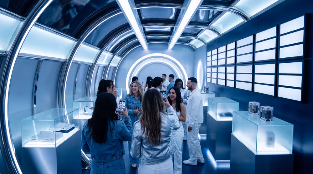 The YYZ Terminal pop-up: a white arrivals hall lit ice blue, fans walking through (placeholder render, replace with the client’s photography)