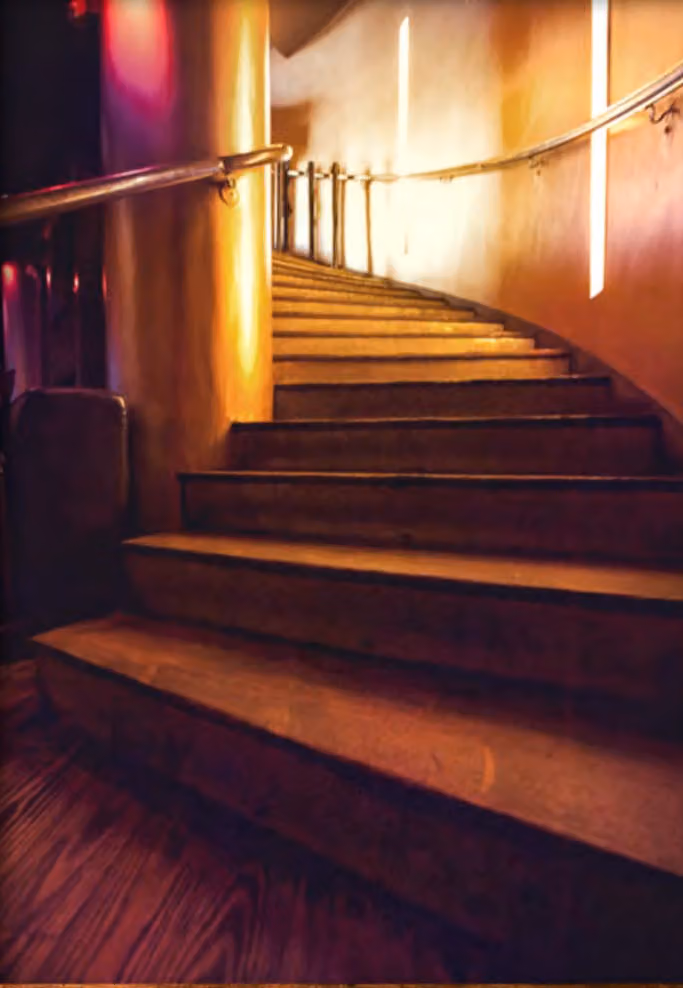 The curved staircase down into Downstairs