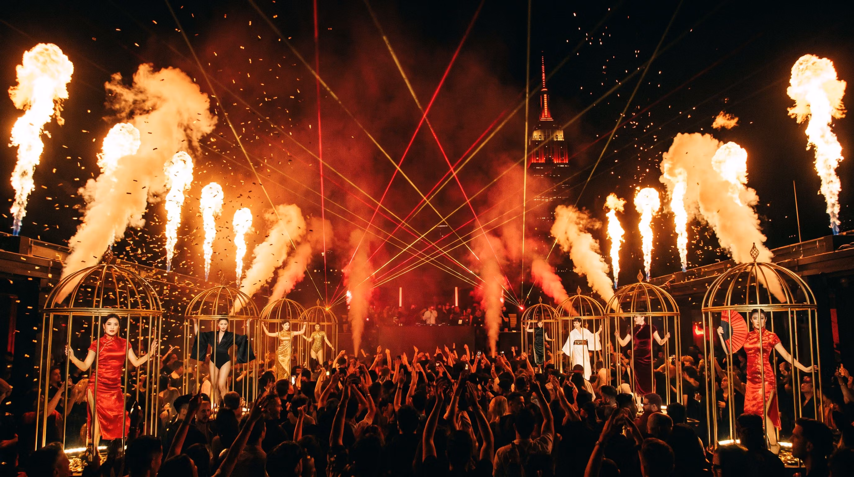 Flame columns, gold confetti and lasers at the peak of the night on the rooftop