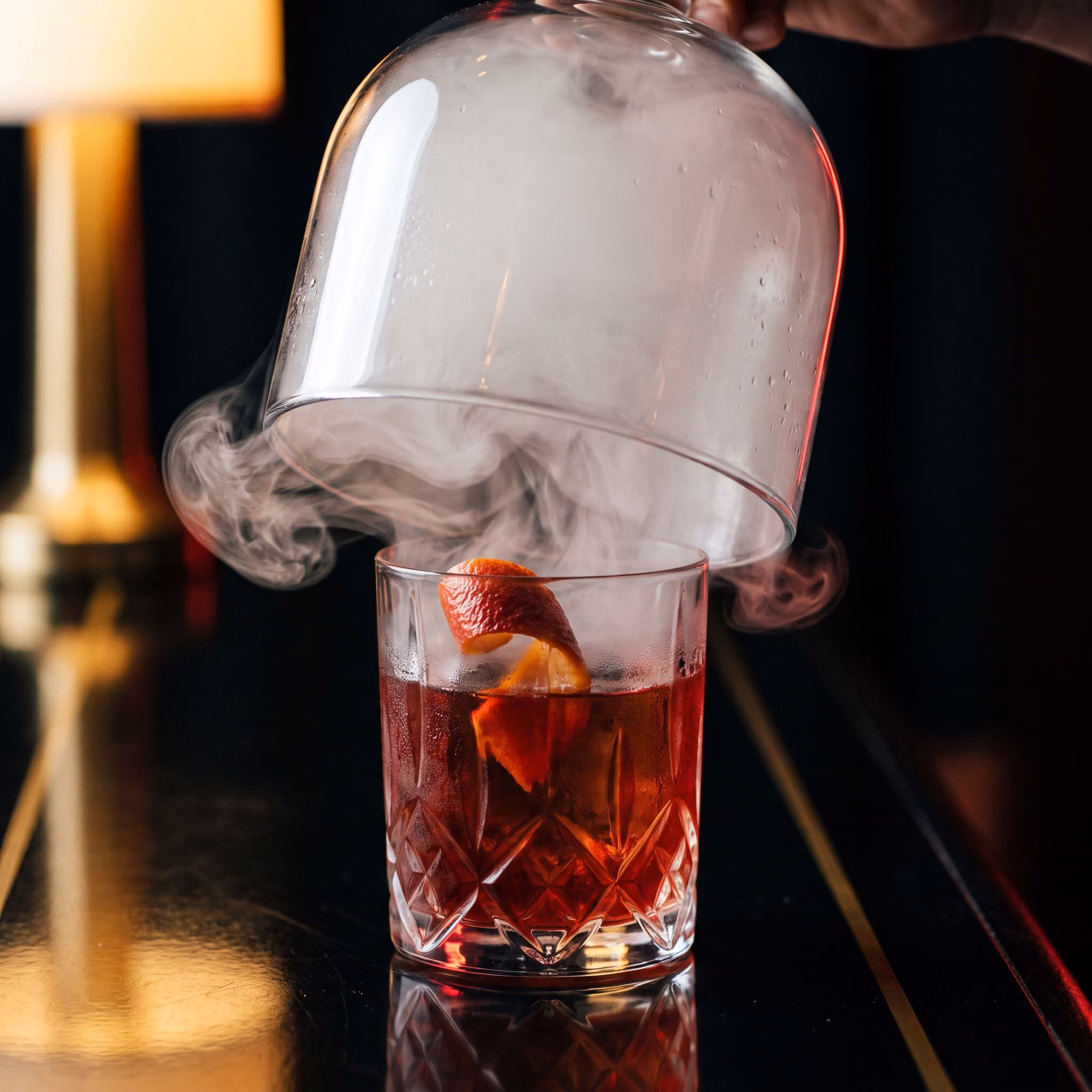 Dragon's Breath cocktail under a smoke-filled cloche