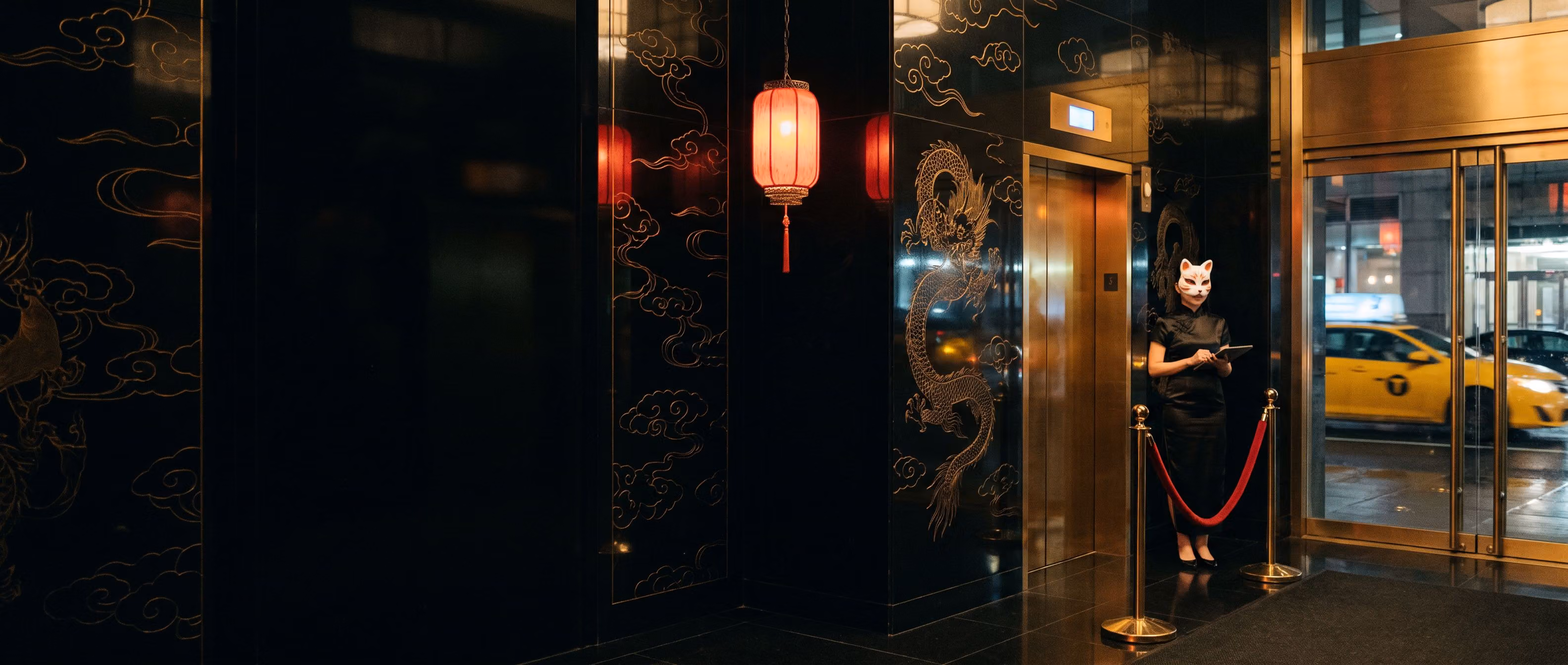The lacquer elevator lobby, a masked host beside a velvet rope and a red lantern