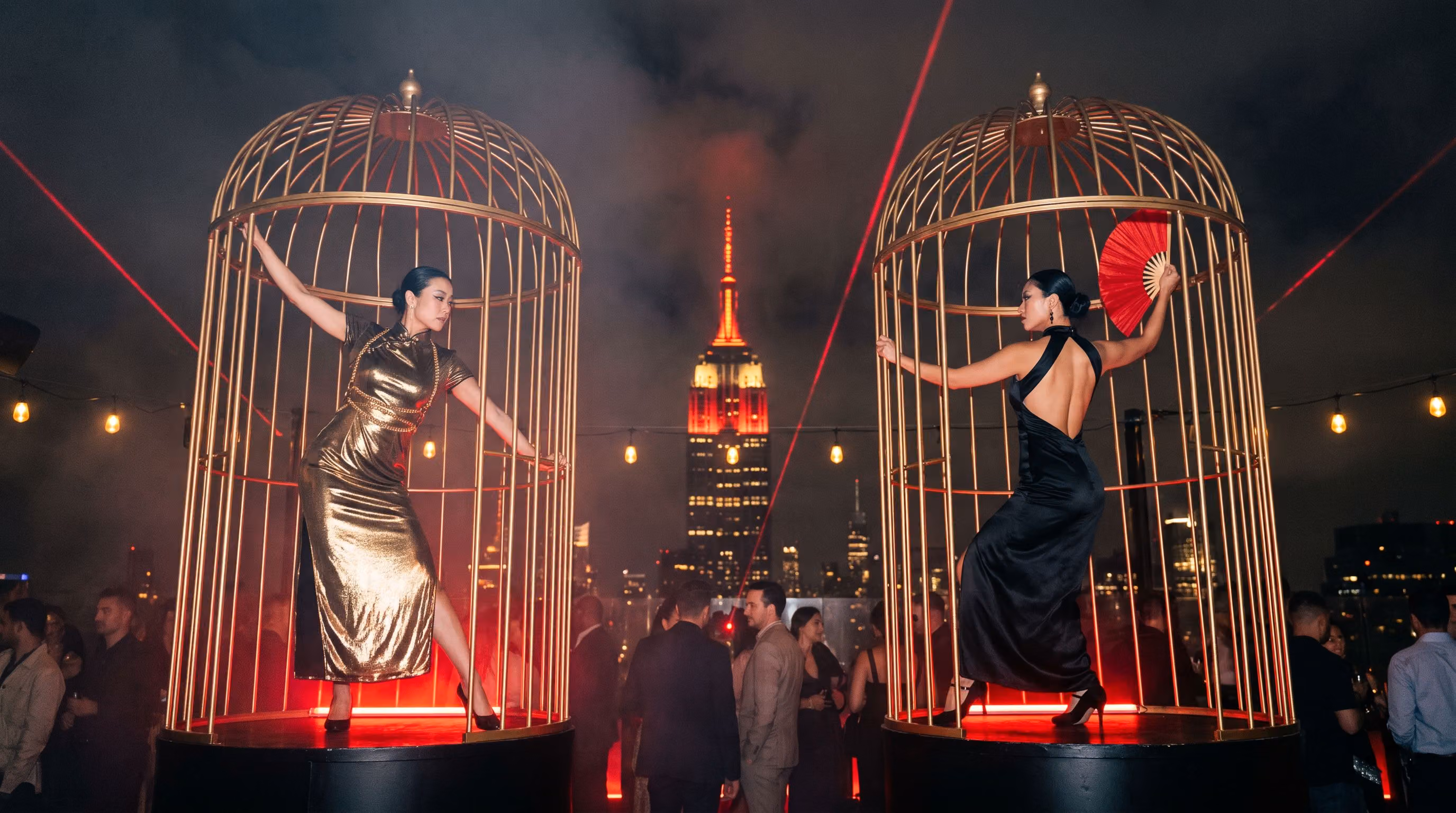 Two dancers in gold cages, one in liquid gold and one in black satin with a red fan, the Empire State Building framed between them