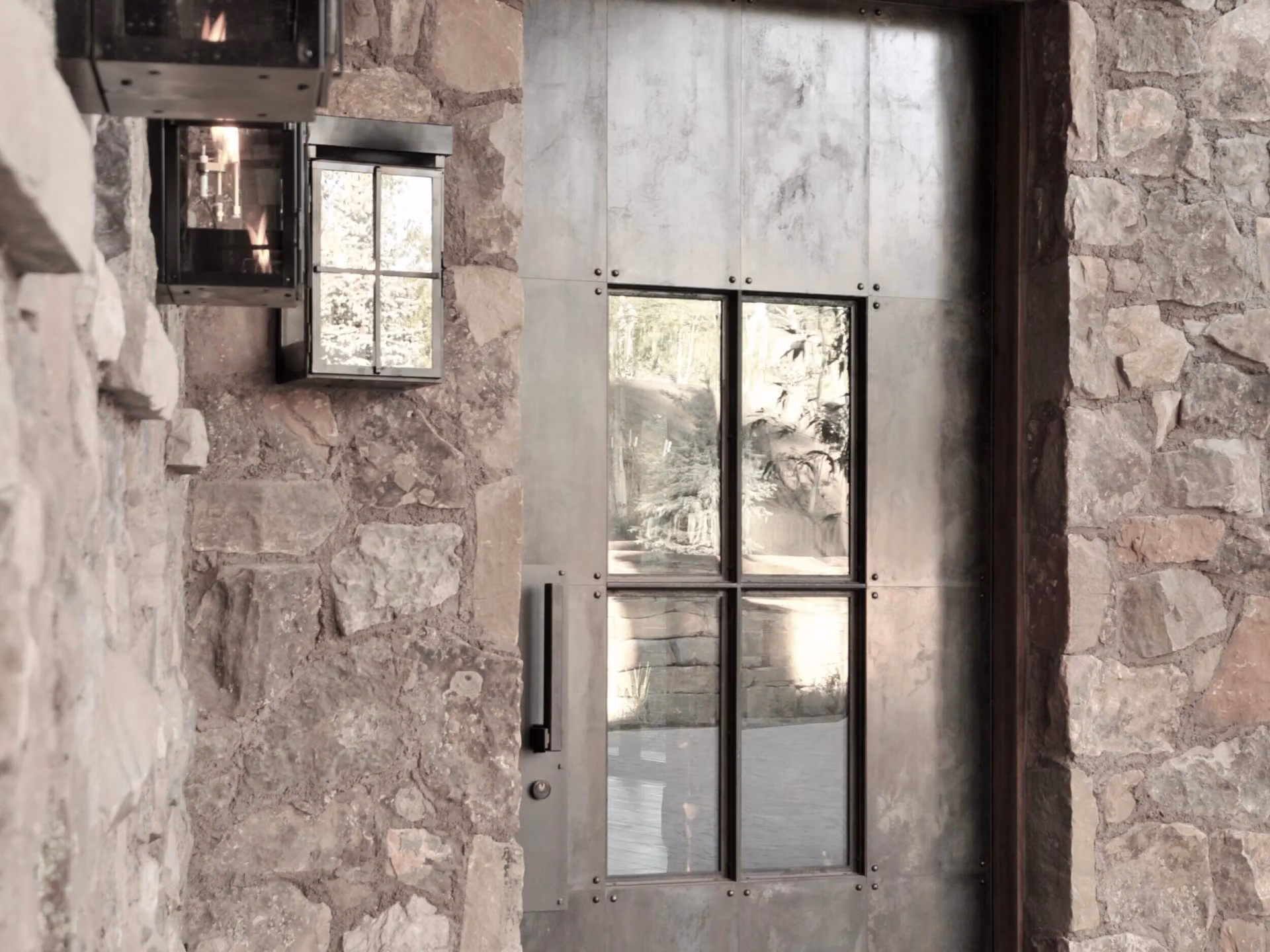 A fabricated steel entry door set into stone