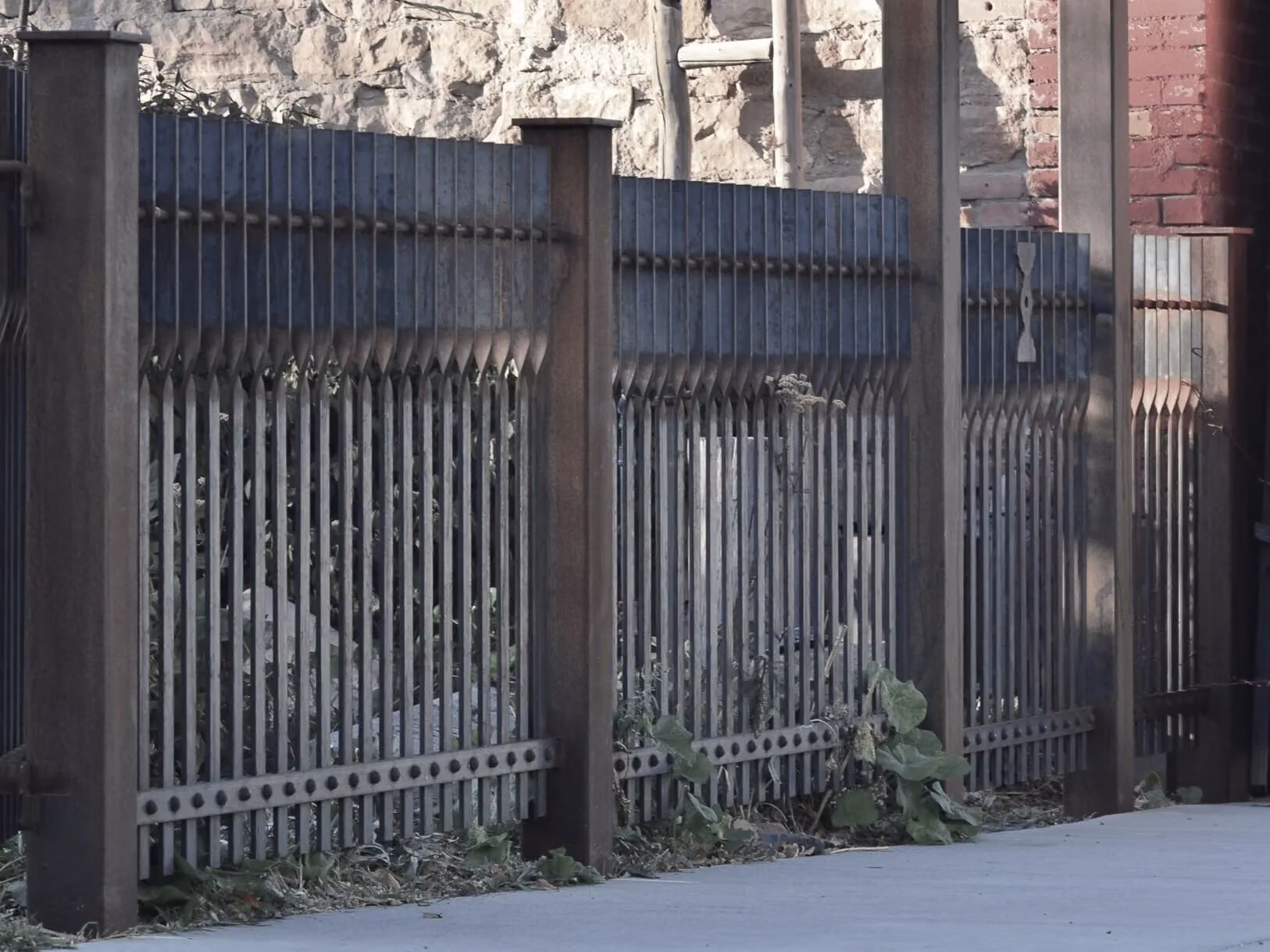A forged fence along a street