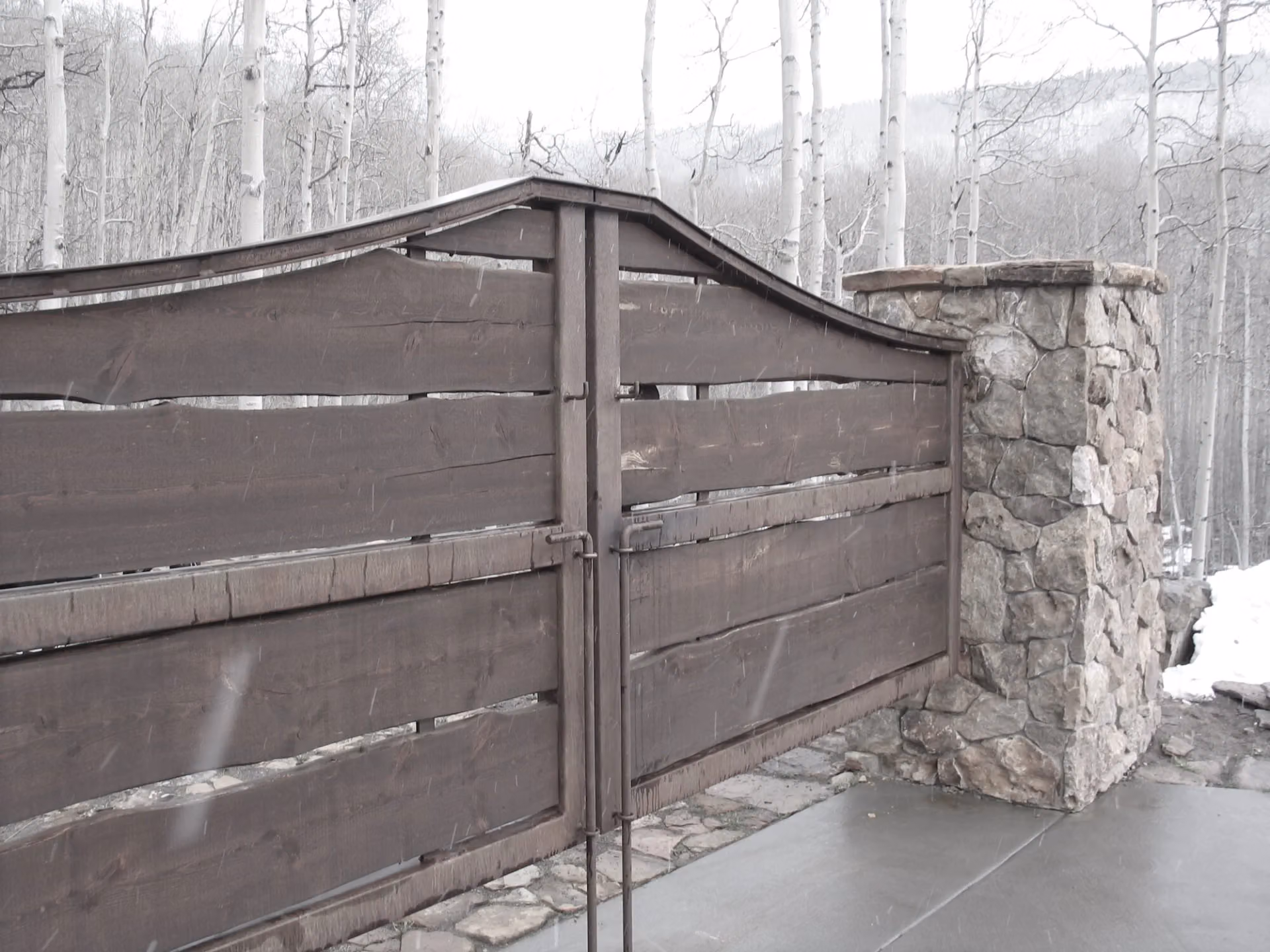 A forged iron gate at a house in the snow above Telluride