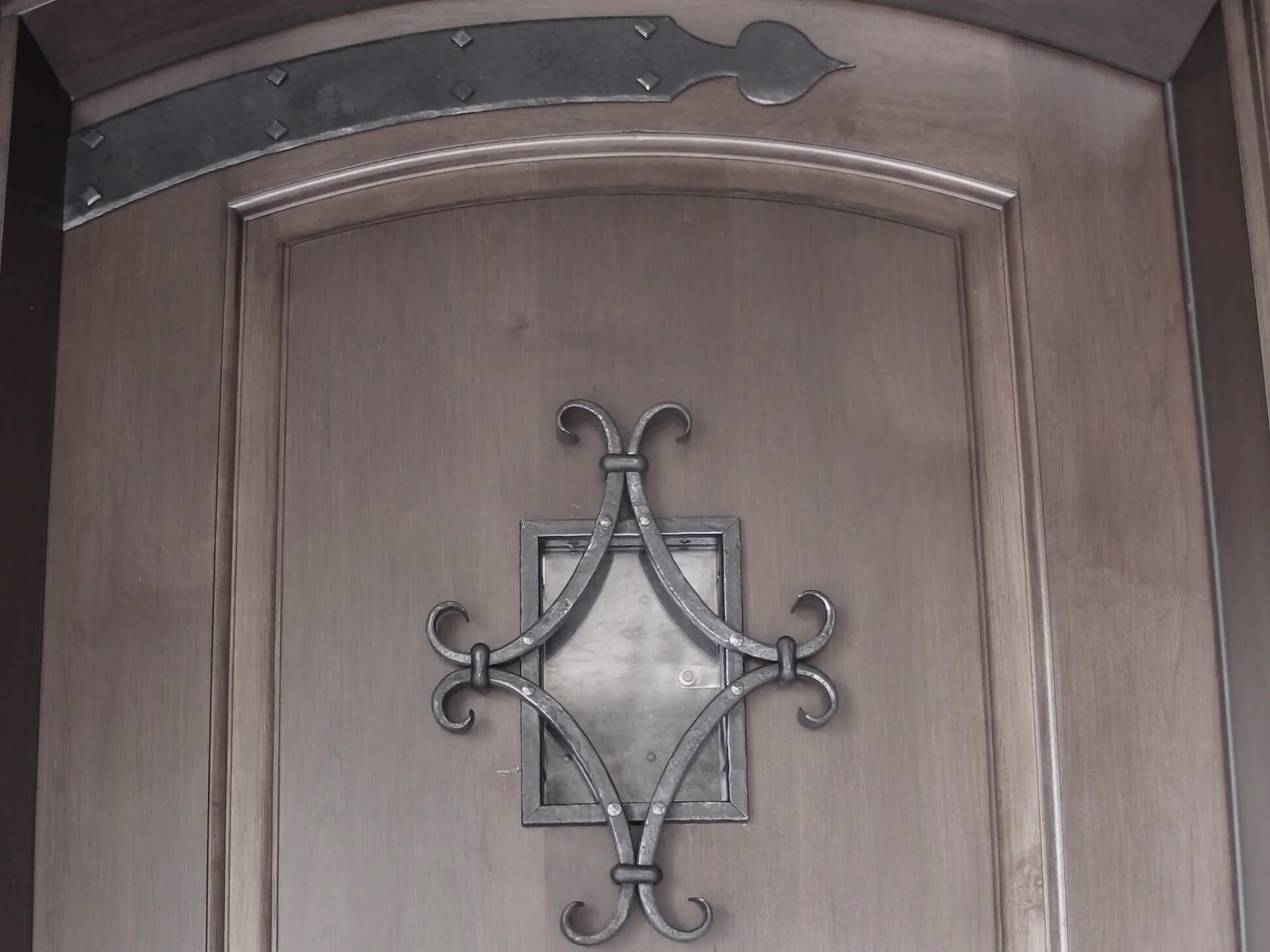 A forged escutcheon on a wooden door