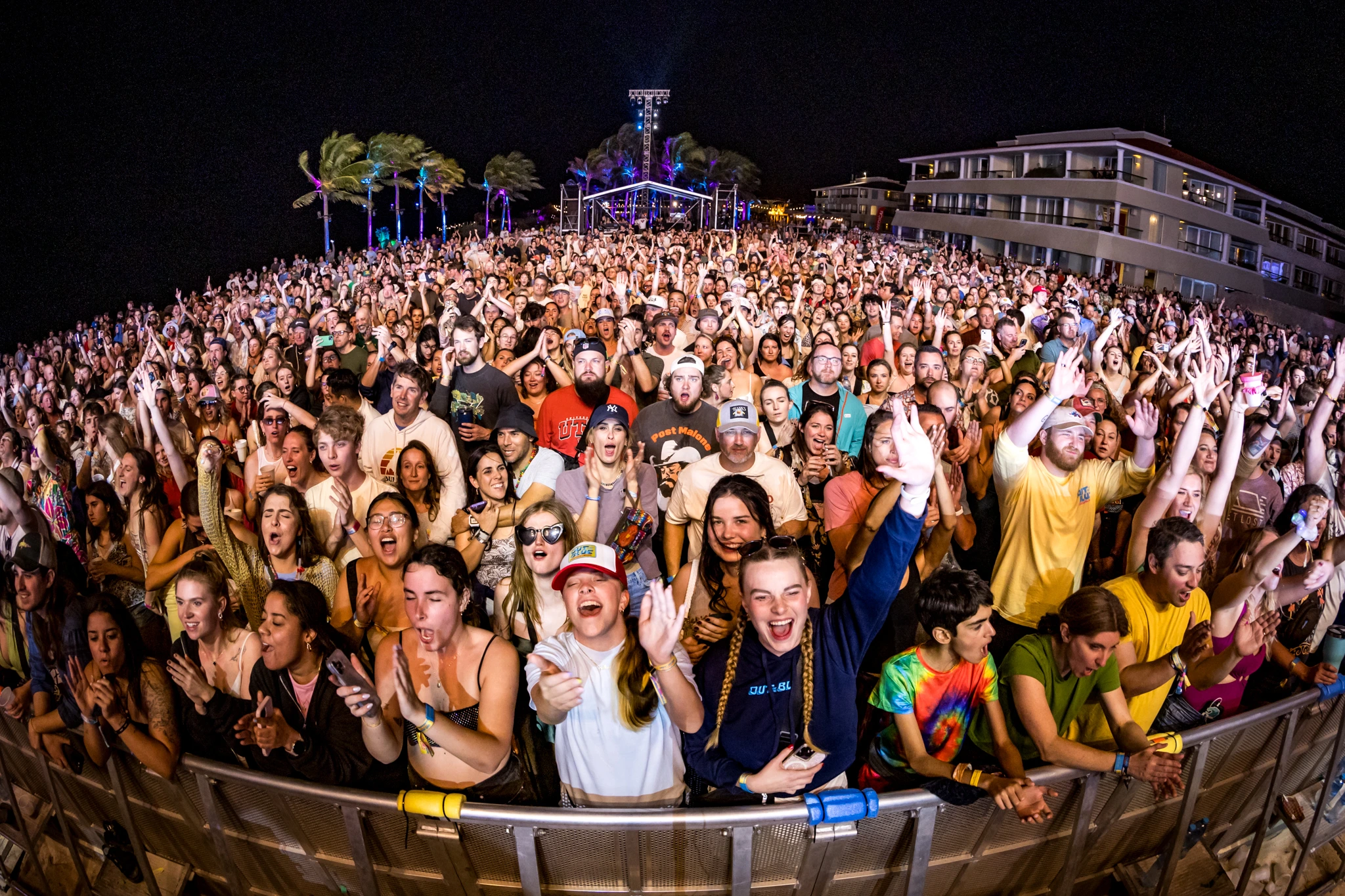 Guests and artists at a beachside festival activity