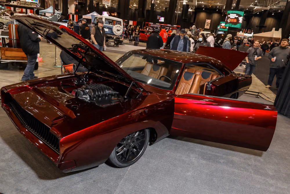 A candy red Chevelle with its doors open