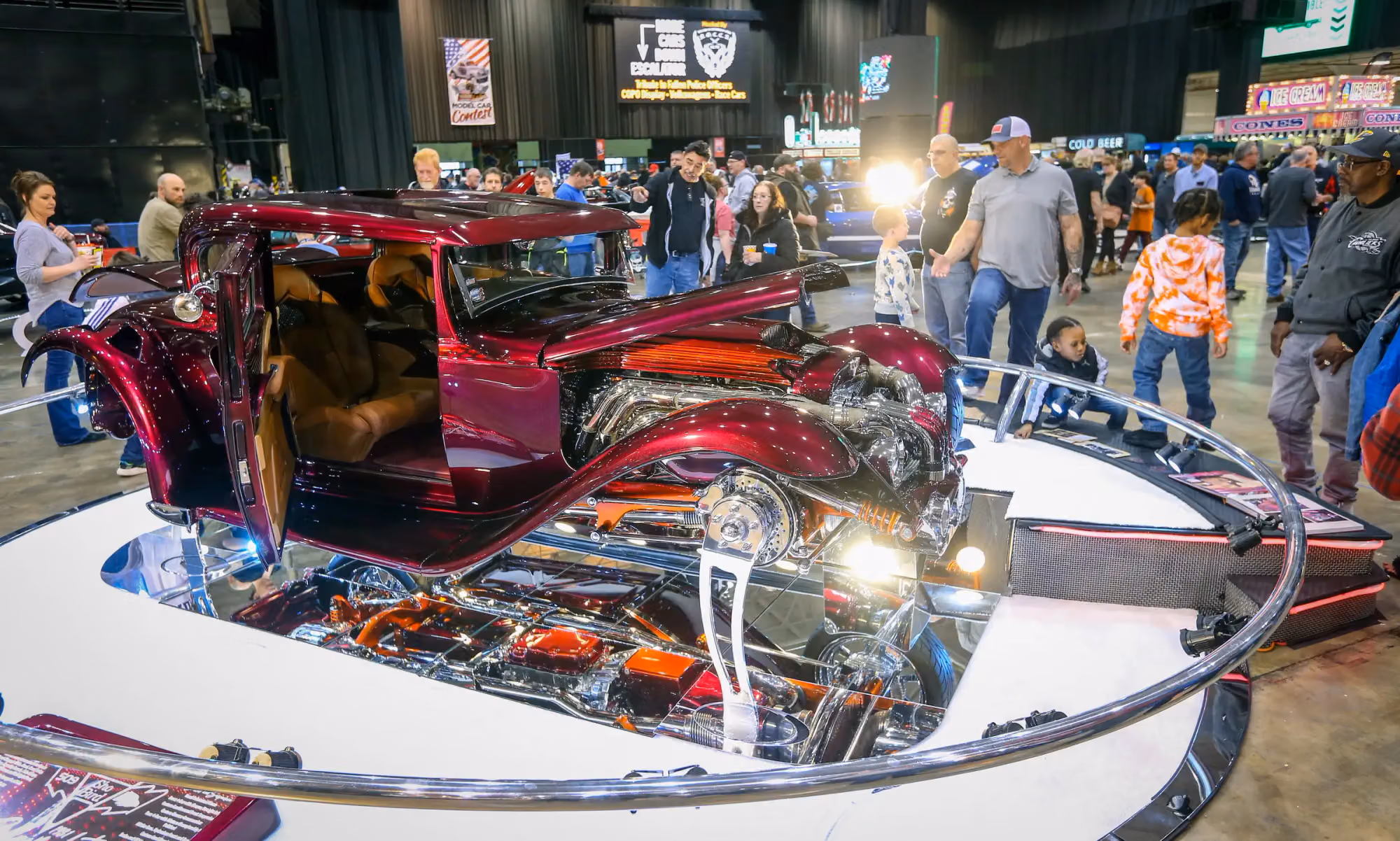 A candy red roadster on a turntable, seen from above