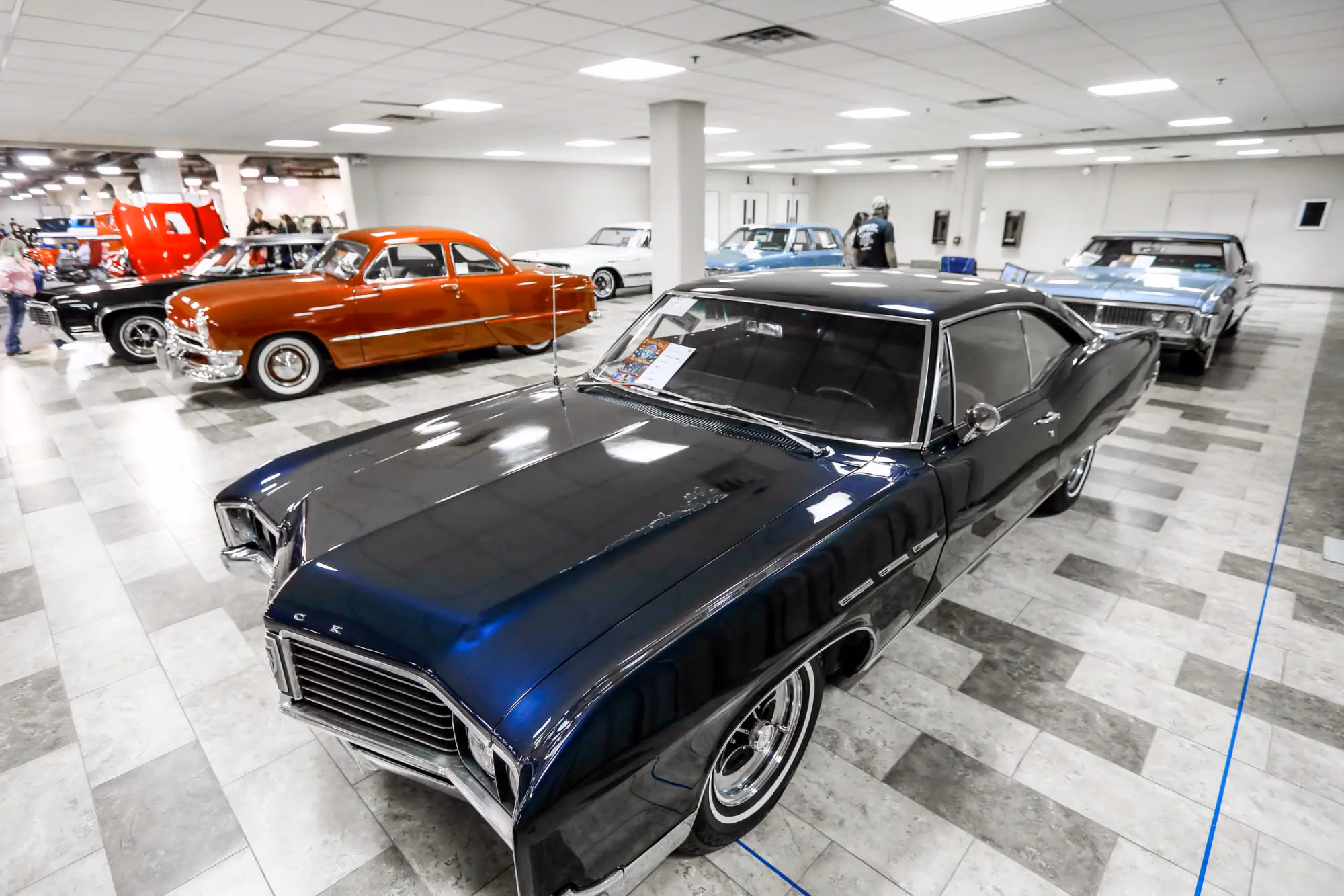 A black sixties Riviera on a tiled floor