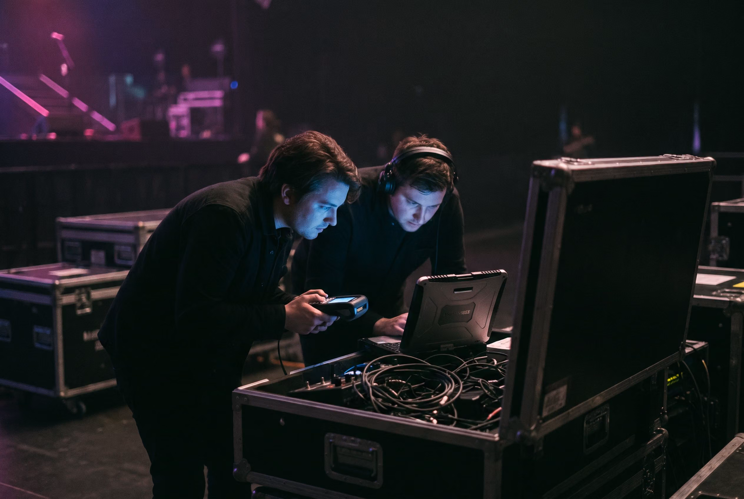 Engineers configuring systems backstage