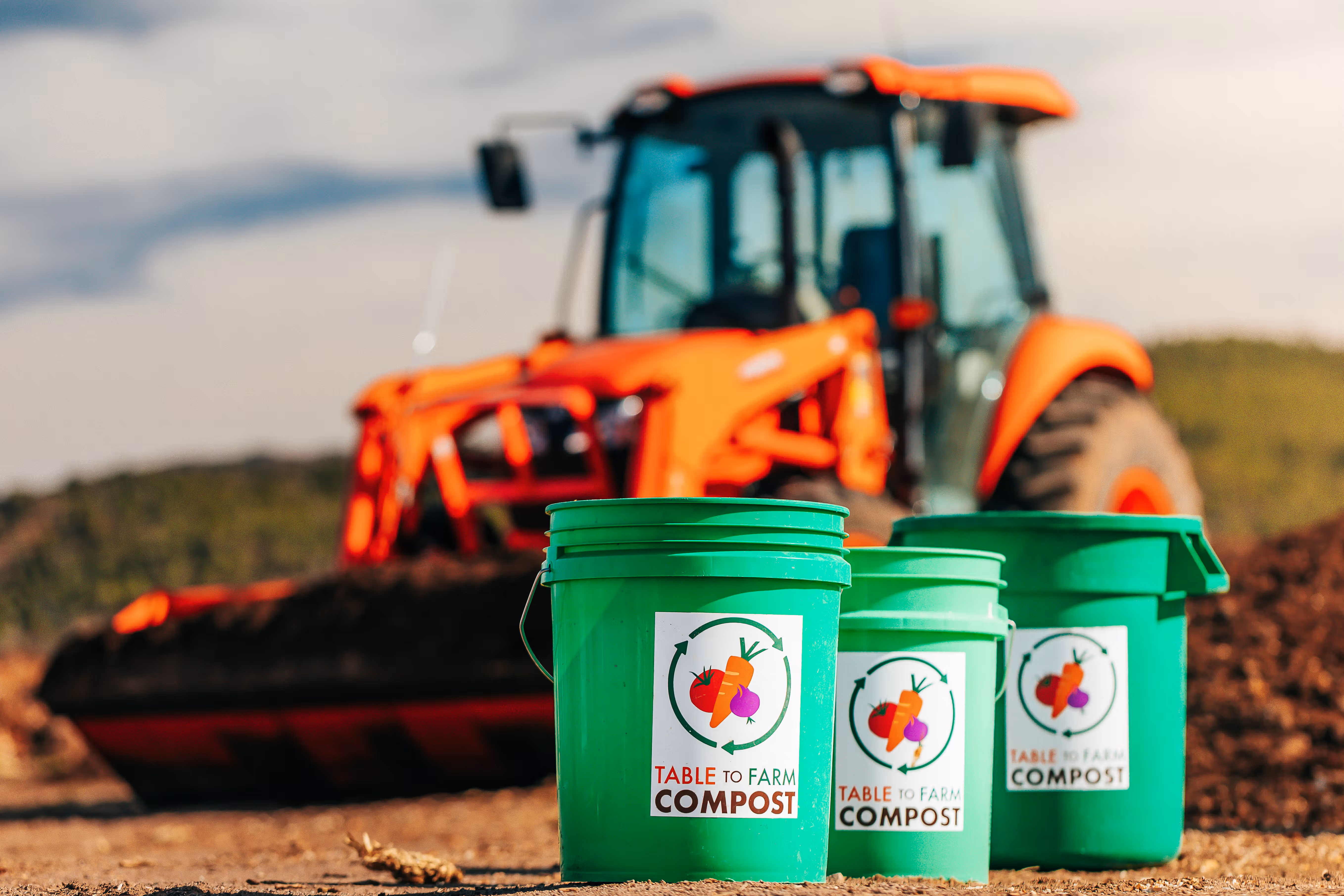 Compost windrows steaming at a Colorado farm at golden hour