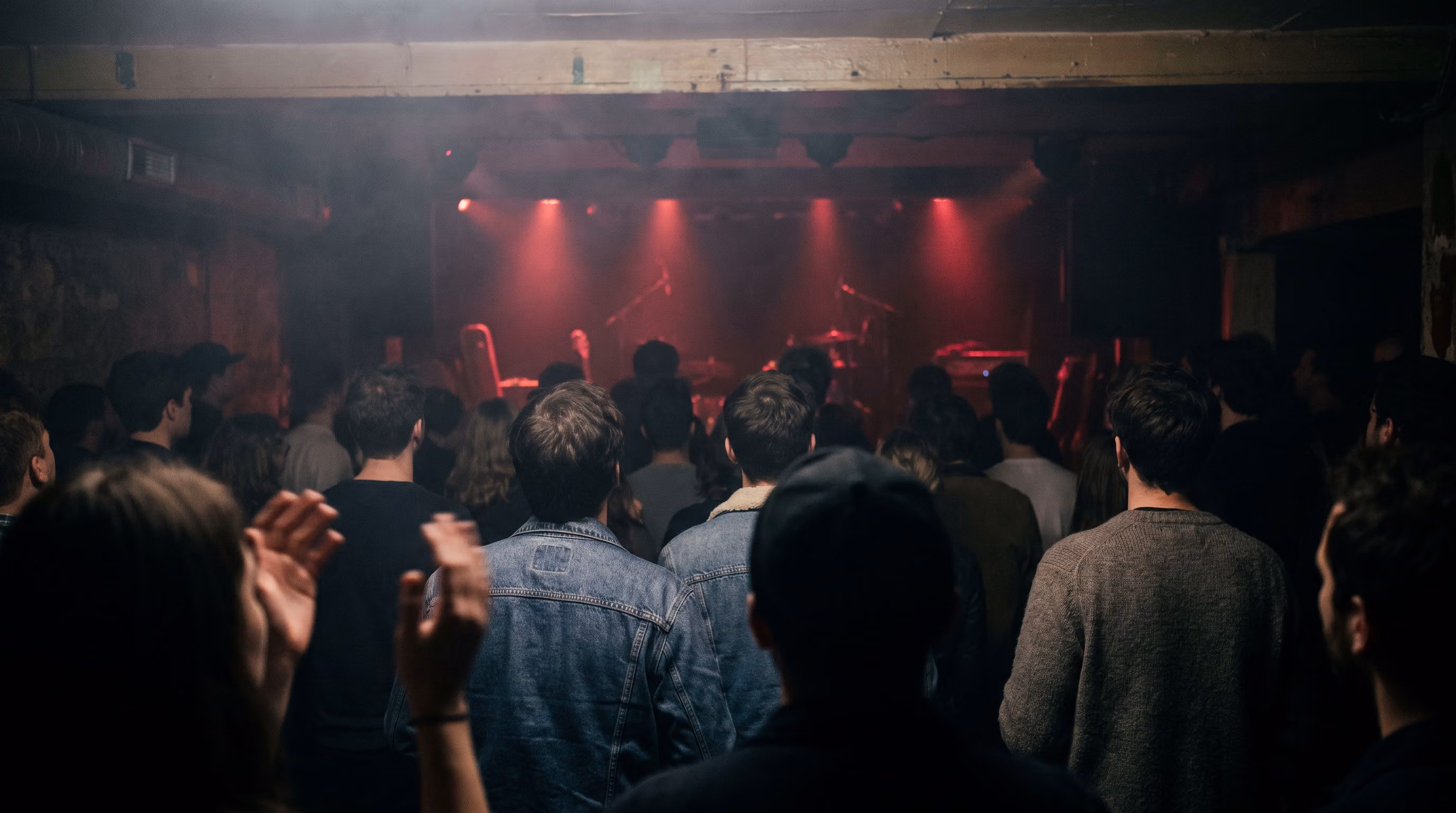 Crowd cheering close to the stage in red light