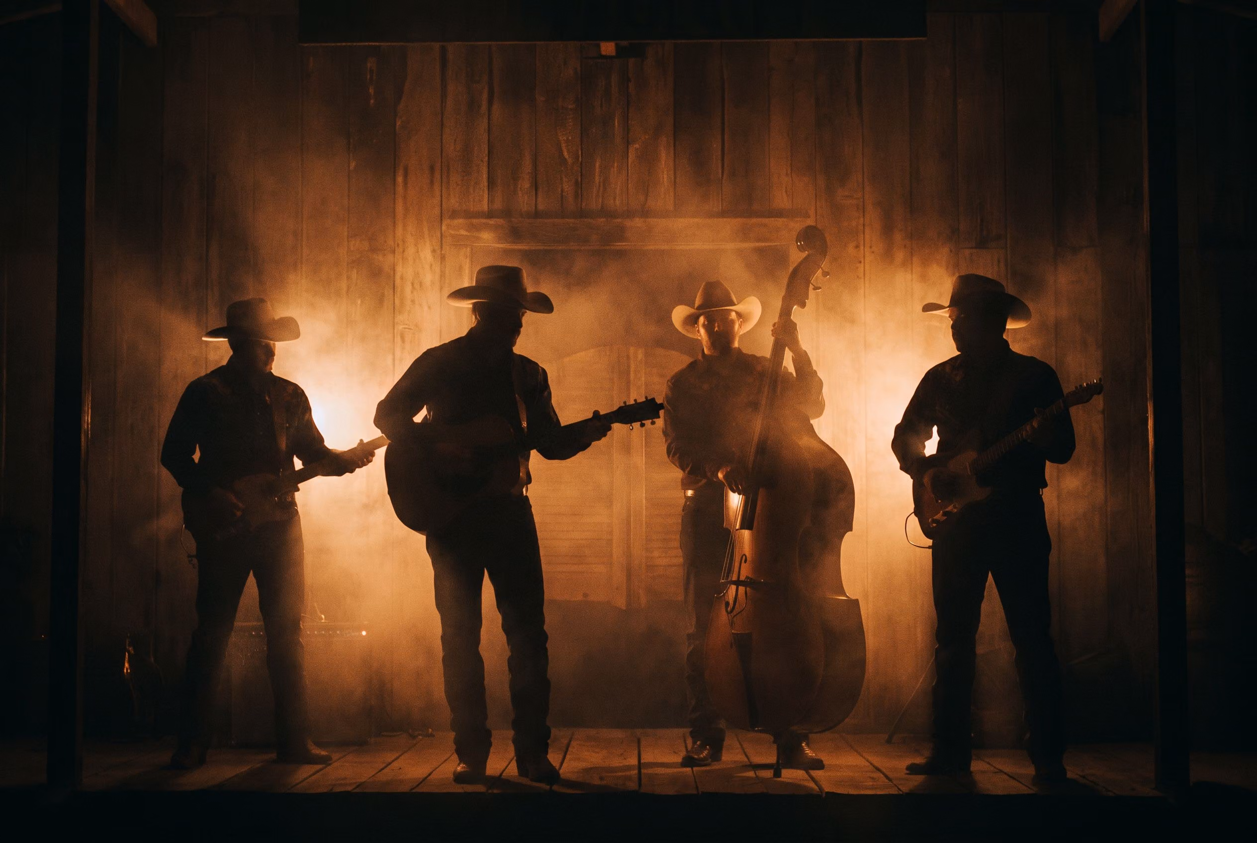 A band playing the Wildwood Saloon stage under warm amber light