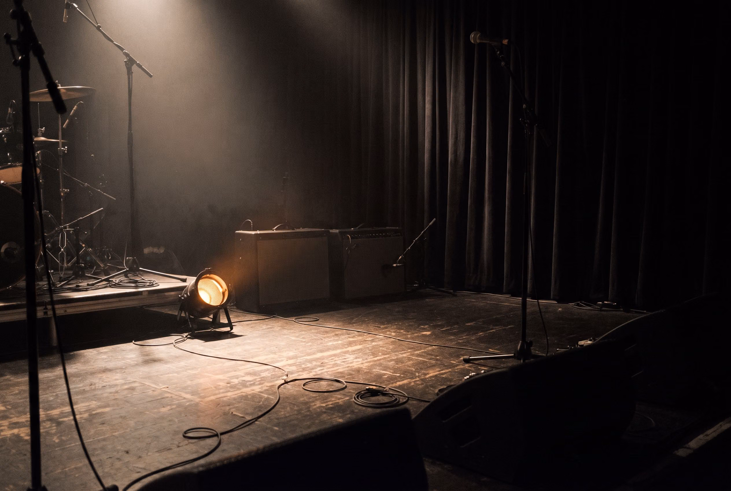 The Wildwood Saloon stage set with amps and microphone stands before doors