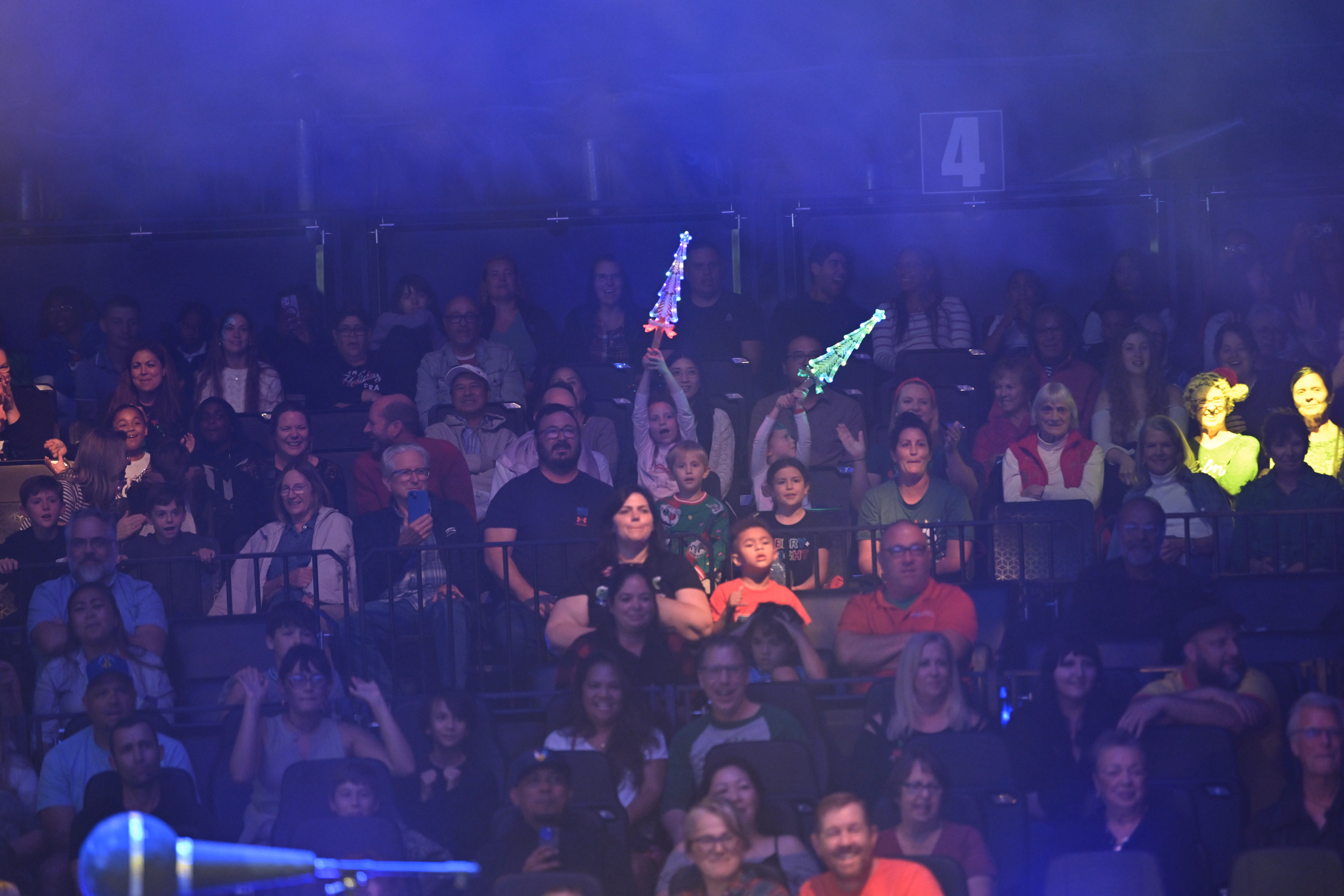 Families in the audience under the Wonderland big top