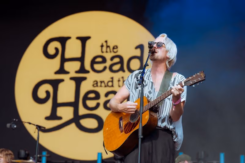Singer with acoustic guitar performing on stage