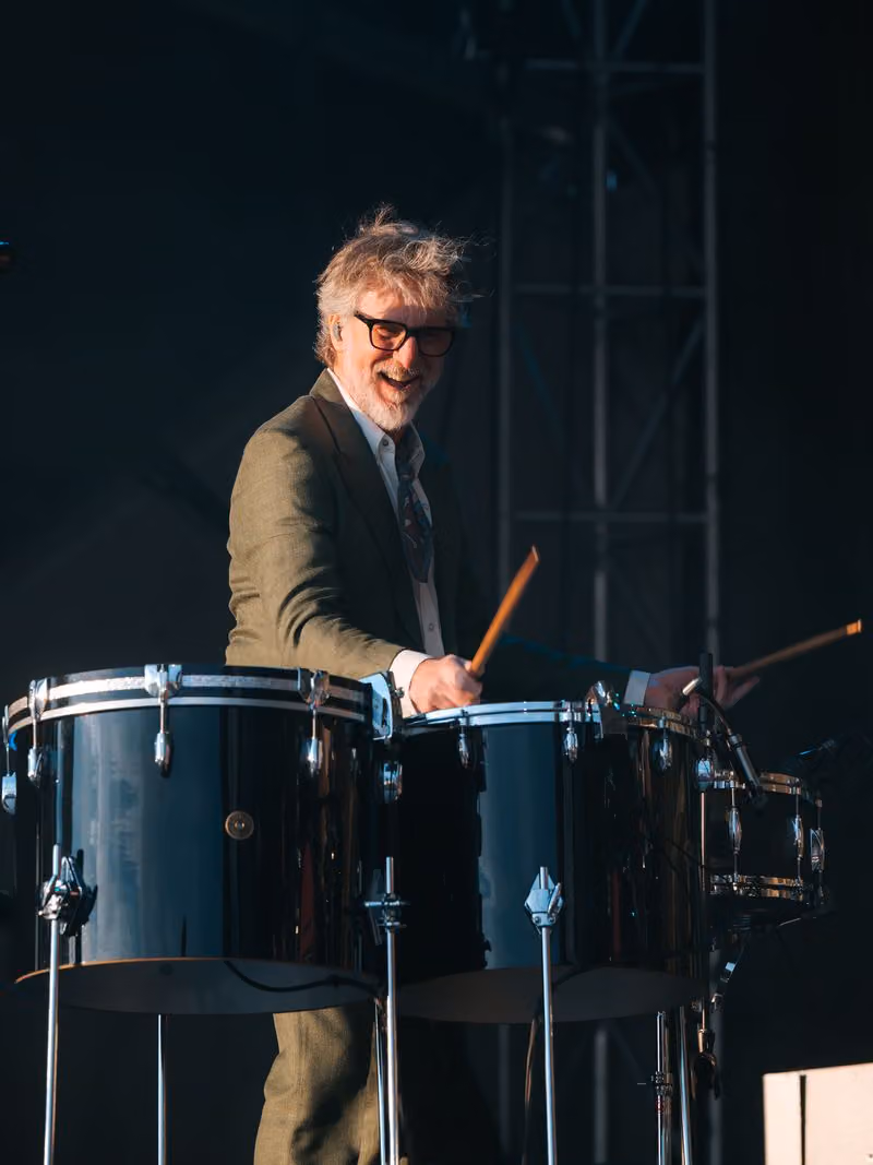 Drummer smiling while performing on stage