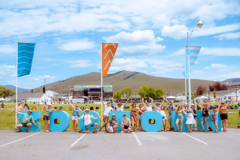 Group of festivalgoers posing with the giant ZOOTOWN letters