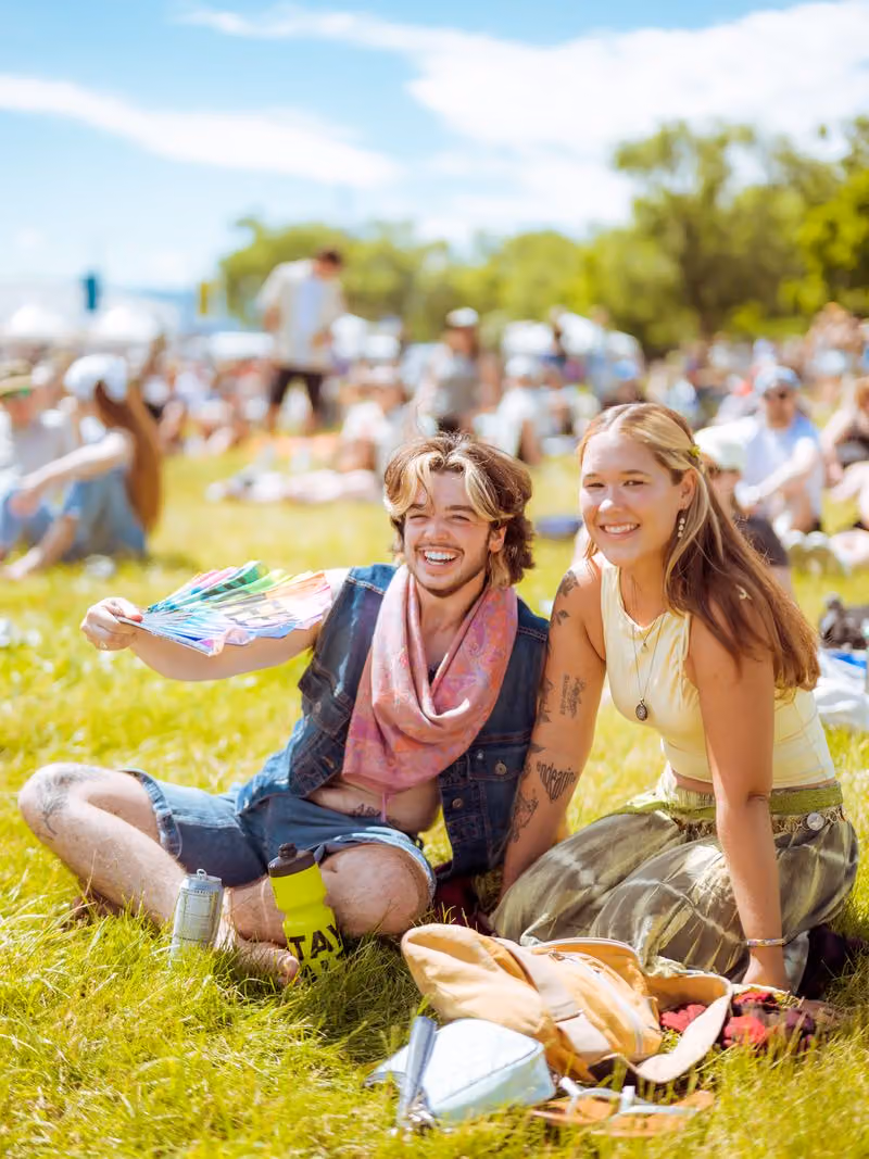 Couple sitting on the grass enjoying the festival