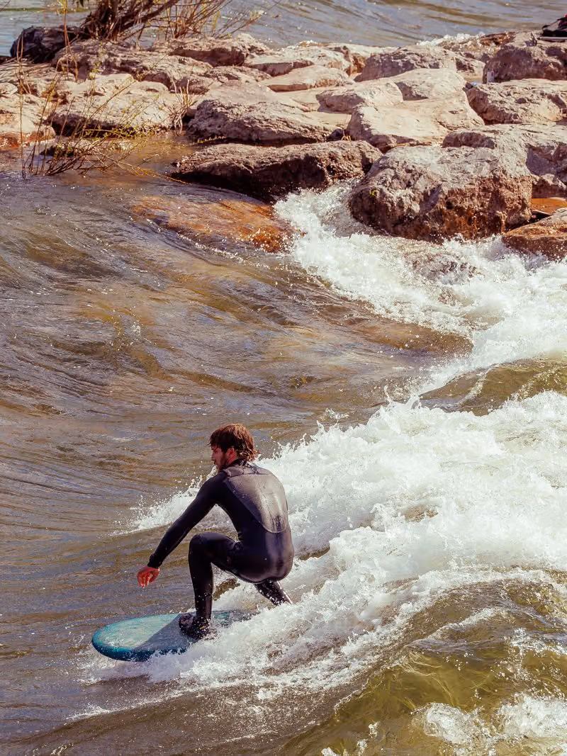 Surfer riding a river wave in Missoula